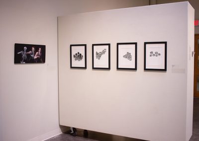 Four prints and a photo at the embody exhibition.
