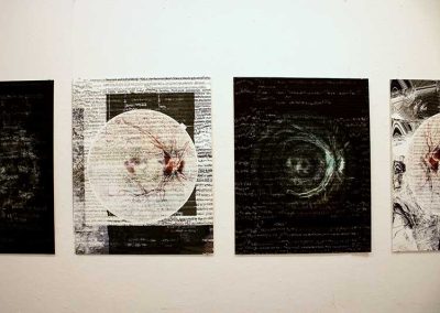 A series of four printed digital collages on the gallery wall.