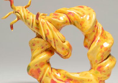 A yellow and orange abstract loop sculpture.